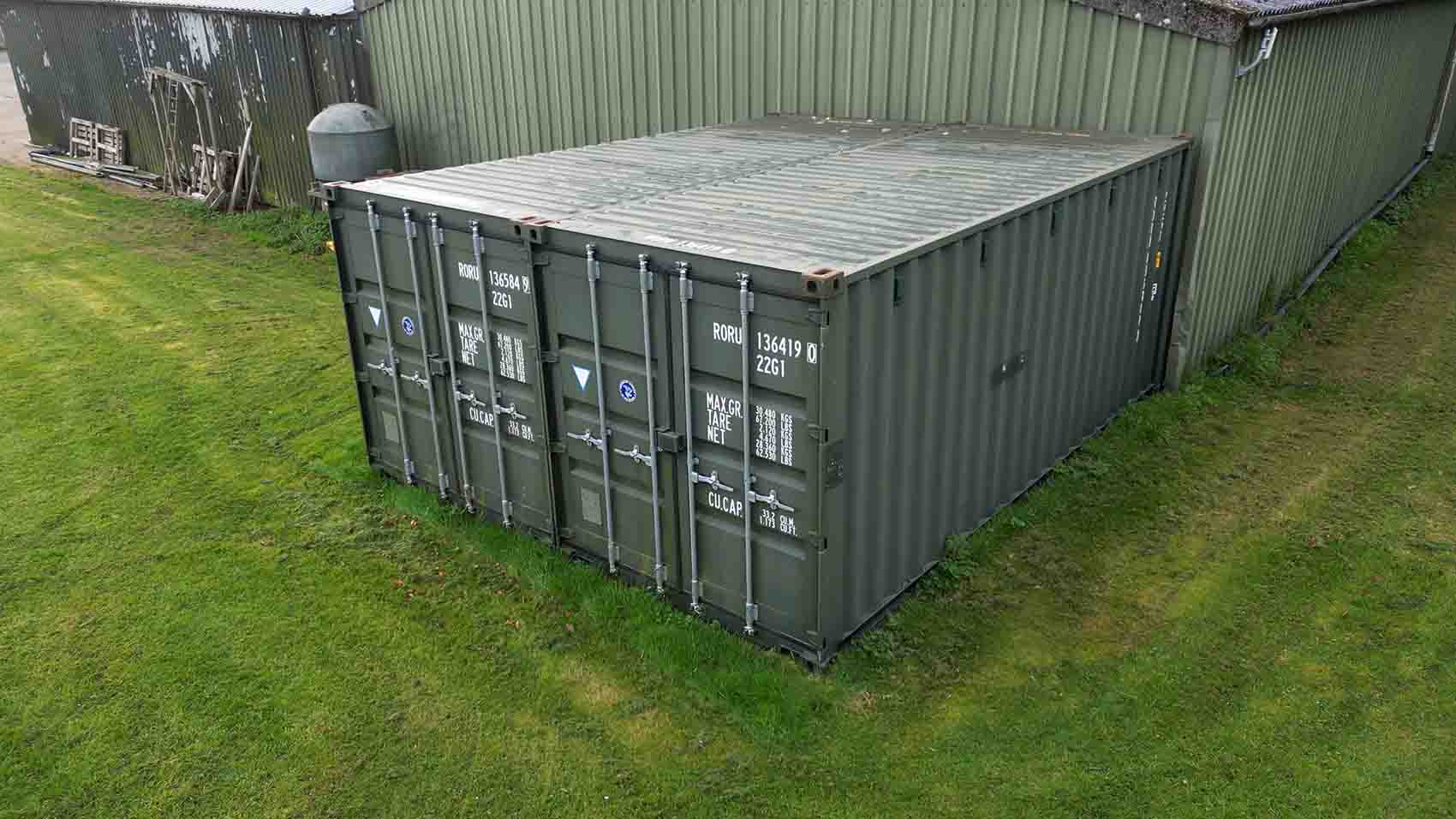 Two green 20ft storage containers on the grass at Temple Bruer